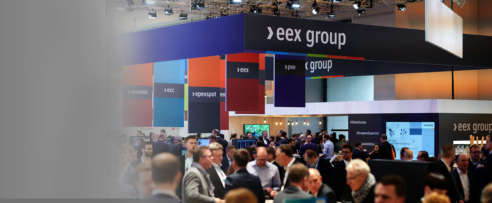 Crowded exhibition hall with EEX Group booths and attendees.